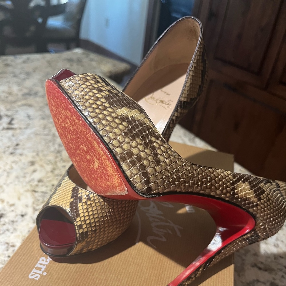 Genuine Christian Louboutin Python pumps.